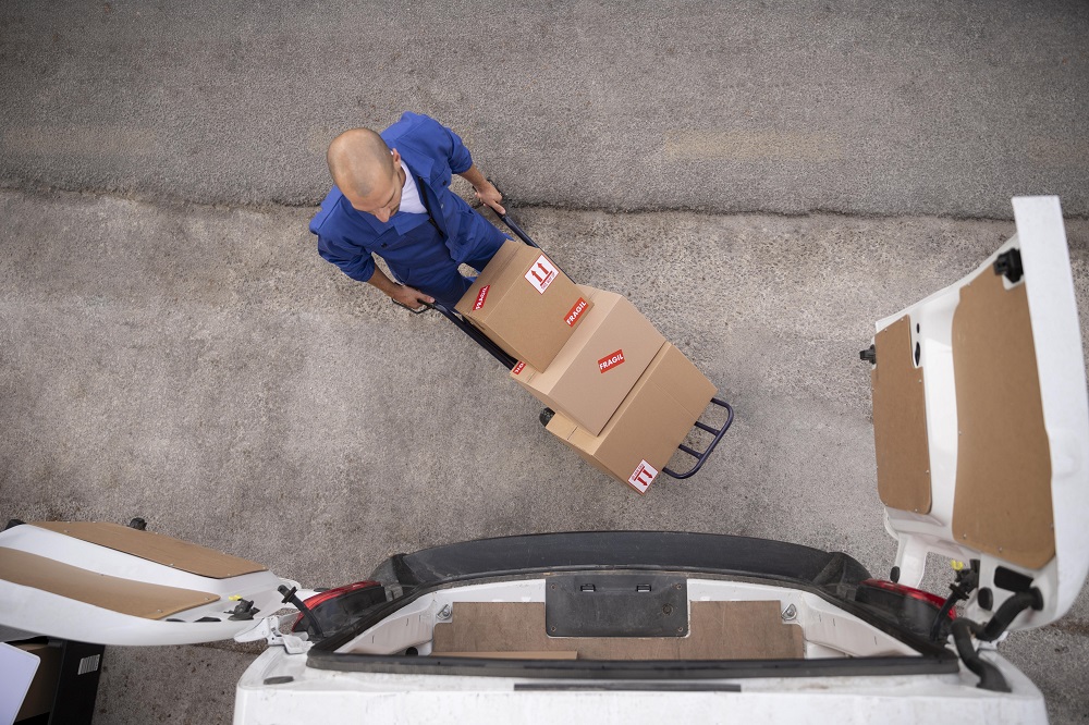full-shot-delivery-man-carrying-boxes-top-view